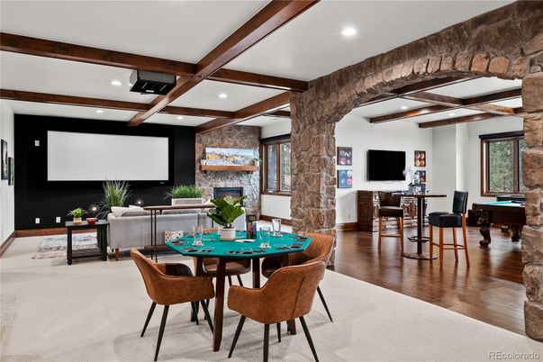 Dining room, Fireplace, Interior, Living room, Projection Screen, Recessed Lighting, Stone Walls, Wooden Beams, Wood Texture Flooring