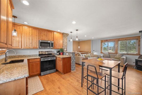 Dining room, Interior, Kitchen, Living room, Pendant Lights, Recessed Lighting, Stainless Steel Appliances, Wood Texture Flooring