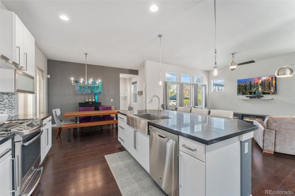 Chandelier, Dining room, Interior, Kitchen, Living room, Pendant Lights, Recessed Lighting, Stainless Steel Appliances, Wood Texture Flooring