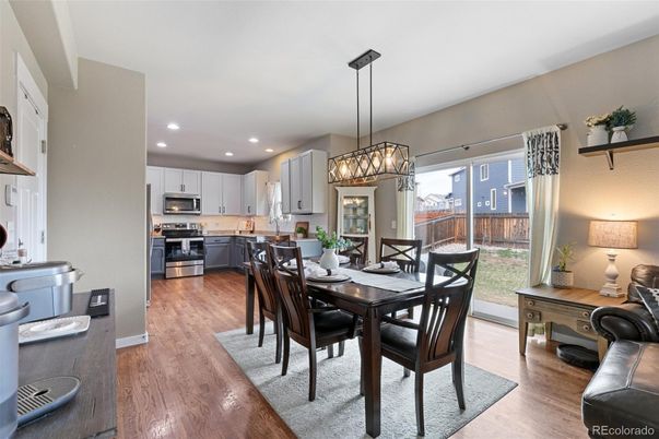 Chandelier, Dining room, Interior, Kitchen, Pendant Lights, Recessed Lighting, Stainless Steel Appliances, Wood Texture Flooring