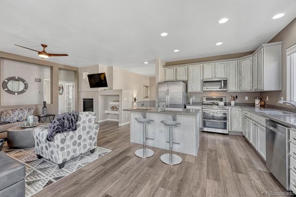 Fireplace, Interior, Kitchen, Recessed Lighting, Stainless Steel Appliances, Wood Texture Flooring