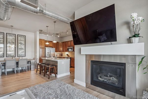 Dining room, Fireplace, Interior, Kitchen, Pendant Lights, Stainless Steel Appliances, Wood Texture Flooring