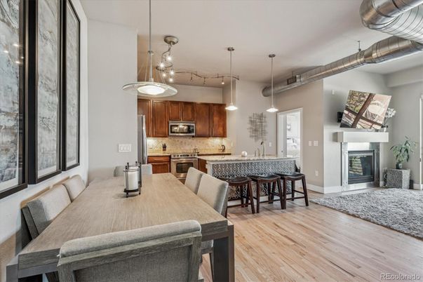 Dining room, Fireplace, Interior, Kitchen, Pendant Lights, Stainless Steel Appliances, Wood Texture Flooring