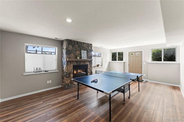 Fireplace, Game Room, Interior, Recessed Lighting, Wood Texture Flooring