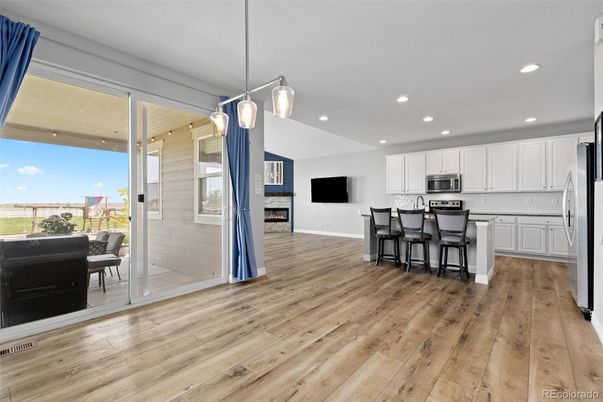 Fireplace, Interior, Kitchen, Pendant Lights, Recessed Lighting, Stainless Steel Appliances, Wood Texture Flooring