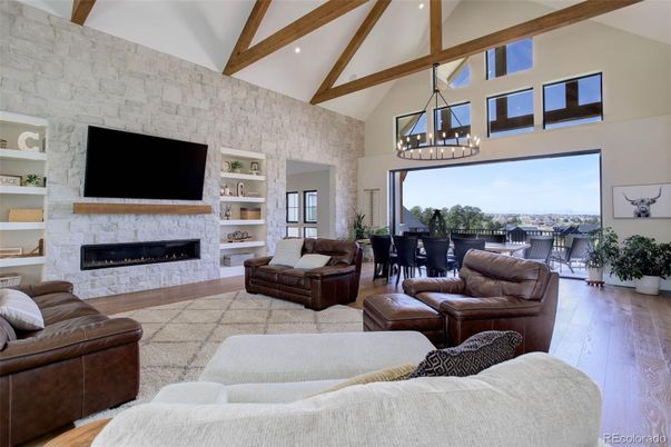 Chandelier, Dining room, Fireplace, Interior, Living room, Pendant Lights, Recessed Lighting, Stone Walls, Wooden Beams, Wood Texture Flooring