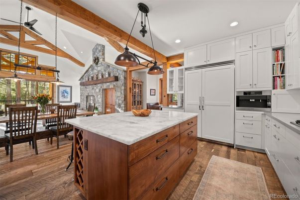 Dining room, Fireplace, Interior, Kitchen, Pendant Lights, Recessed Lighting, Stainless Steel Appliances, Stone Walls, Wooden Beams, Wood Texture Flooring