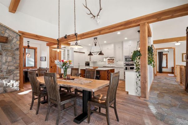 Dining room, Fireplace, Interior, Kitchen, Pendant Lights, Recessed Lighting, Stainless Steel Appliances, Stone Walls, Wooden Beams, Wood Texture Flooring