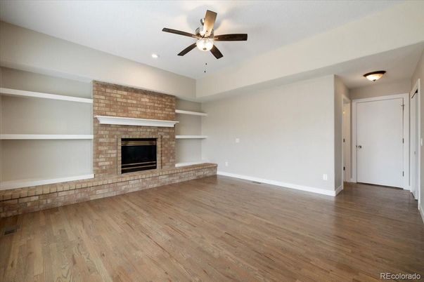 Empty room, Fireplace, Interior, Recessed Lighting, Stone Walls, Wood Texture Flooring