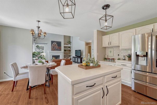 Chandelier, Dining room, Fireplace, Interior, Kitchen, Pendant Lights, Stainless Steel Appliances, Wood Texture Flooring