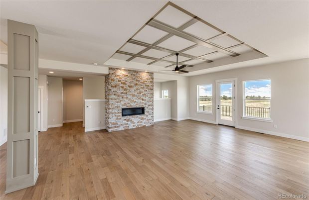 Empty room, Fireplace, Interior, Recessed Lighting, Stone Walls, Wood Texture Flooring