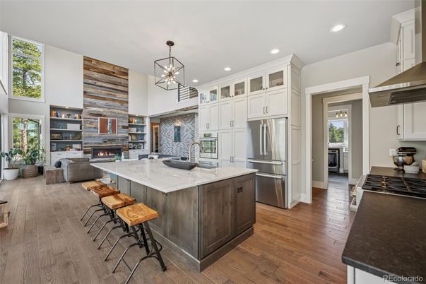 Fireplace, Interior, Kitchen, Living room, Pendant Lights, Recessed Lighting, Stainless Steel Appliances, Wood Texture Flooring