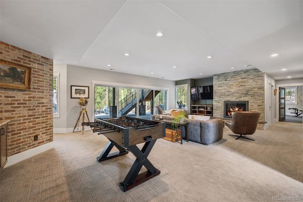 Fireplace, Game Room, Interior, Recessed Lighting, Stone Walls