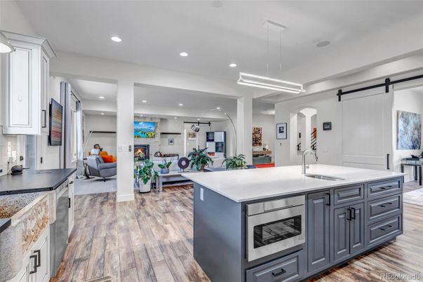 Fireplace, Interior, Kitchen, Living room, Pendant Lights, Recessed Lighting, Stainless Steel Appliances, Wood Texture Flooring
