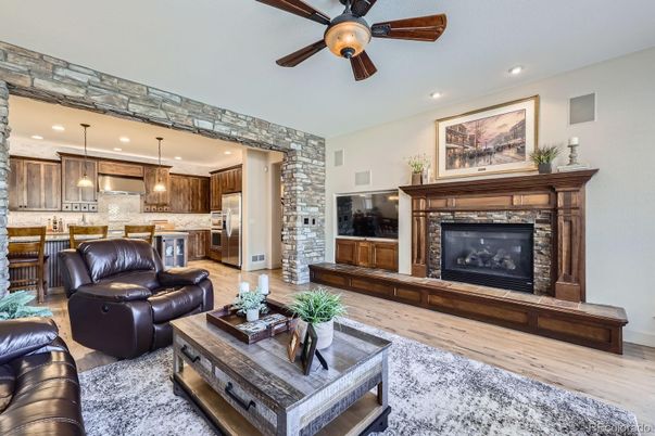 Fireplace, Interior, Kitchen, Living room, Pendant Lights, Recessed Lighting, Stainless Steel Appliances, Stone Walls, Wood Texture Flooring