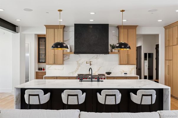 Interior, Kitchen, Marble Walls, Pendant Lights, Recessed Lighting, Stainless Steel Appliances, Wood Texture Flooring