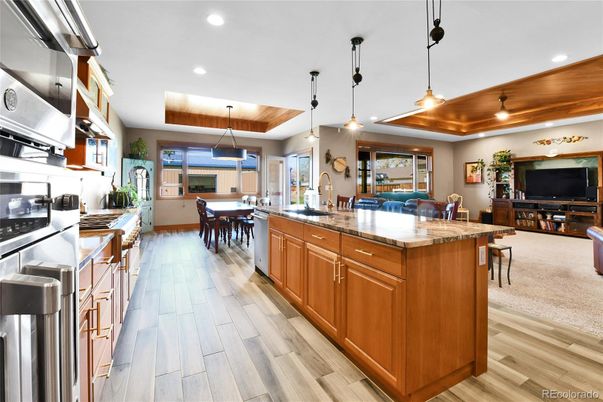 Dining room, Interior, Kitchen, Living room, Pendant Lights, Recessed Lighting, Stainless Steel Appliances, Wooden Ceilings, Wood Texture Flooring