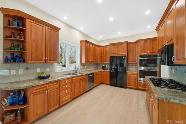 Interior, Kitchen, Recessed Lighting, Stainless Steel Appliances, Tile Countertops, Wood Texture Flooring