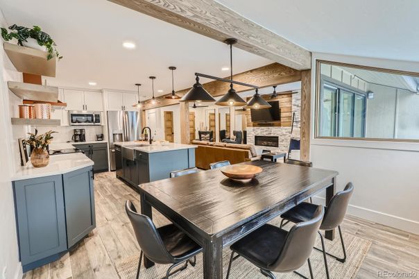 Dining room, Fireplace, Interior, Kitchen, Pendant Lights, Recessed Lighting, Stainless Steel Appliances, Stone Walls, Wooden Beams, Wood Texture Flooring