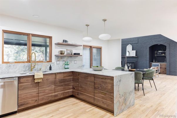 Dining room, Fireplace, Interior, Kitchen, Pendant Lights, Recessed Lighting, Stainless Steel Appliances, Stone Walls, Wood Texture Flooring