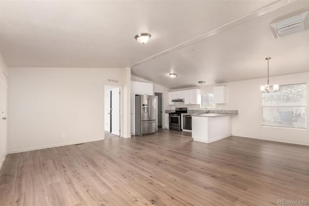 Empty room, Interior, Kitchen, Pendant Lights, Stainless Steel Appliances, Wood Texture Flooring