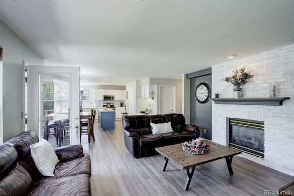 Dining room, Fireplace, Interior, Kitchen, Living room, Recessed Lighting, Stone Walls, Wood Texture Flooring