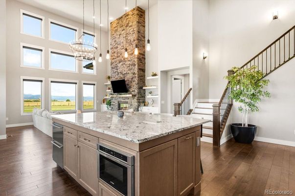 Fireplace, Interior, Kitchen, Pendant Lights, Stone Walls, Water, Wood Texture Flooring