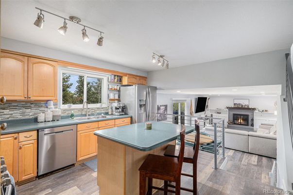 Dining room, Fireplace, Interior, Kitchen, Living room, Recessed Lighting, Stainless Steel Appliances, Wood Texture Flooring