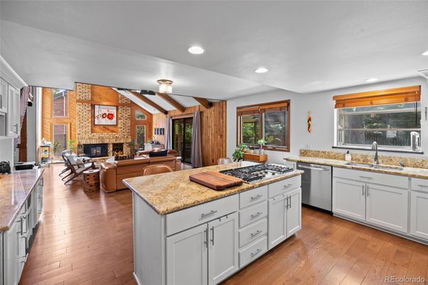 Dining room, Fireplace, Interior, Kitchen, Living room, Recessed Lighting, Stone Walls, Wood Texture Flooring