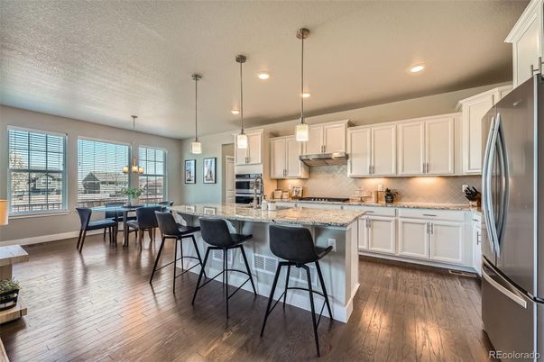 Dining room, Interior, Kitchen, Pendant Lights, Recessed Lighting, Stainless Steel Appliances, Wood Texture Flooring