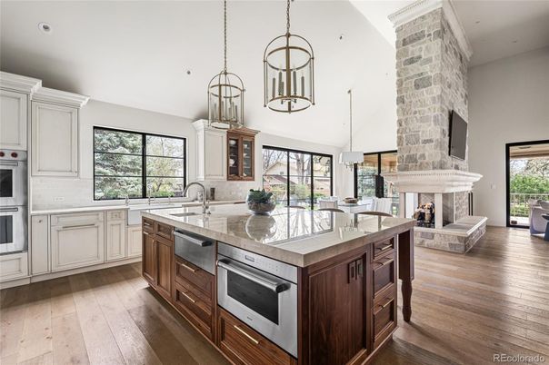 Fireplace, Interior, Kitchen, Pendant Lights, Recessed Lighting, Stainless Steel Appliances, Stone Walls, Wood Texture Flooring