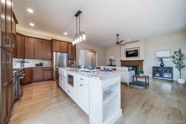 Fireplace, Interior, Kitchen, Living room, Pendant Lights, Recessed Lighting, Stainless Steel Appliances, Wood Texture Flooring