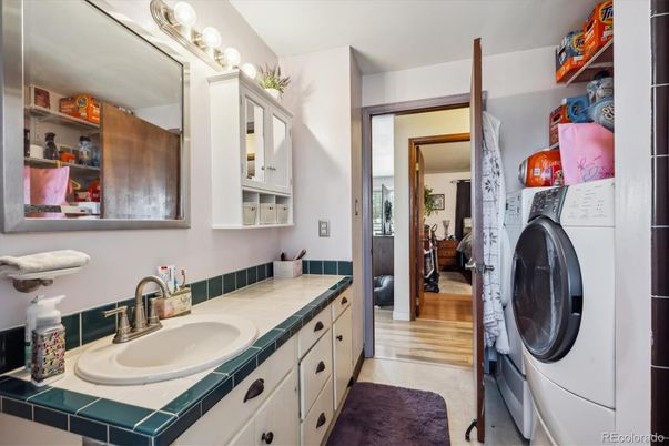 Bathroom, Interior, Tile Countertops, Utility Closets, Washer, Wood Texture Flooring