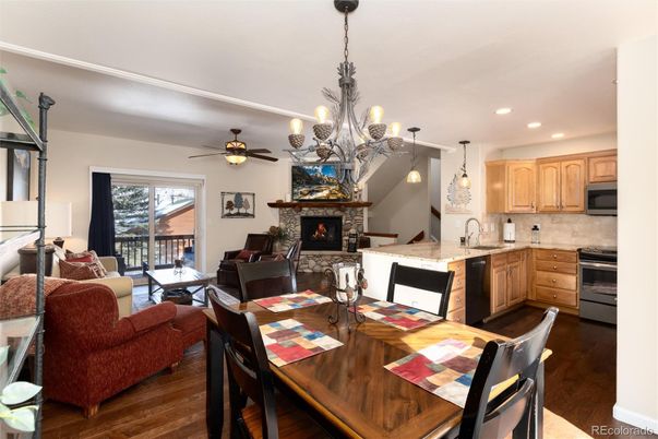 Chandelier, Dining room, Fireplace, Interior, Kitchen, Living room, Pendant Lights, Recessed Lighting, Stainless Steel Appliances, Wood Texture Flooring