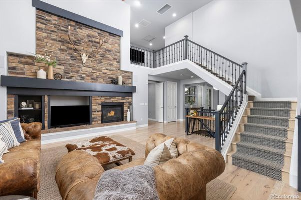 Fireplace, Interior, Living room, Recessed Lighting, Stone Walls, Wood Texture Flooring