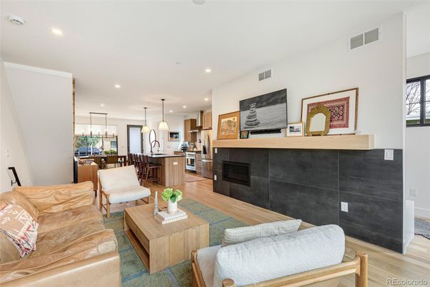 Dining room, Fireplace, Interior, Kitchen, Living room, Pendant Lights, Recessed Lighting, Stainless Steel Appliances, Wood Texture Flooring