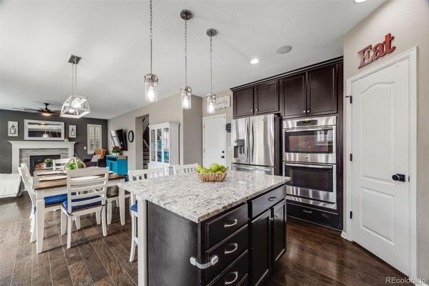 Dining room, Fireplace, Interior, Kitchen, Pendant Lights, Recessed Lighting, Stainless Steel Appliances, Wood Texture Flooring