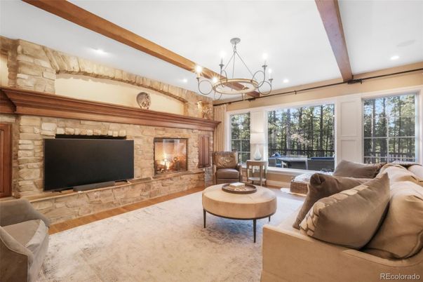 Chandelier, Fireplace, Interior, Living room, Recessed Lighting, Stone Walls, Wooden Beams