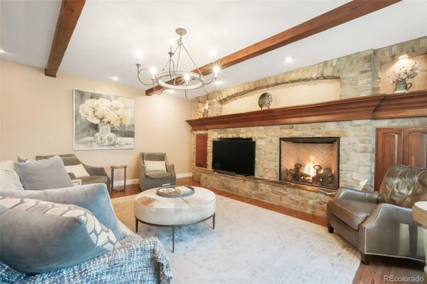 Chandelier, Fireplace, Interior, Living room, Recessed Lighting, Stone Walls, Wooden Beams, Wood Texture Flooring
