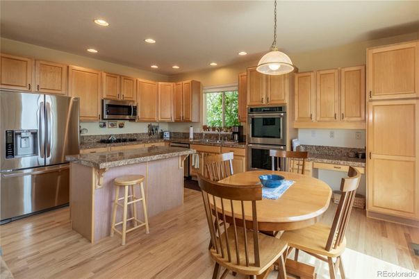 Dining room, Interior, Kitchen, Pendant Lights, Recessed Lighting, Stainless Steel Appliances, Wood Texture Flooring