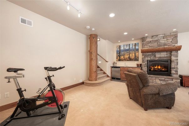Fireplace, Fitness Equipment, Interior, Living room, Recessed Lighting, Stone Walls