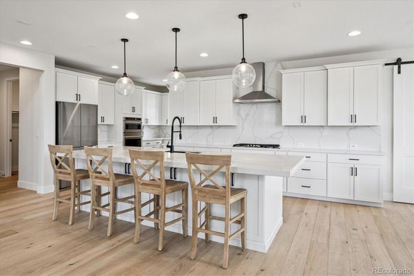 Interior, Kitchen, Marble Walls, Pendant Lights, Recessed Lighting, Stainless Steel Appliances, Wood Texture Flooring