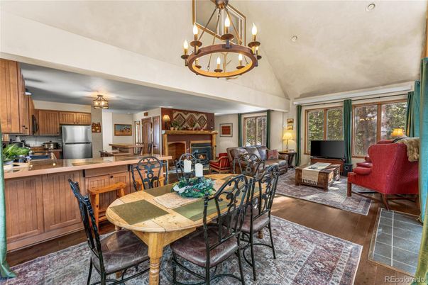 Chandelier, Dining room, Interior, Kitchen, Living room, Pendant Lights, Stainless Steel Appliances, Wood Texture Flooring