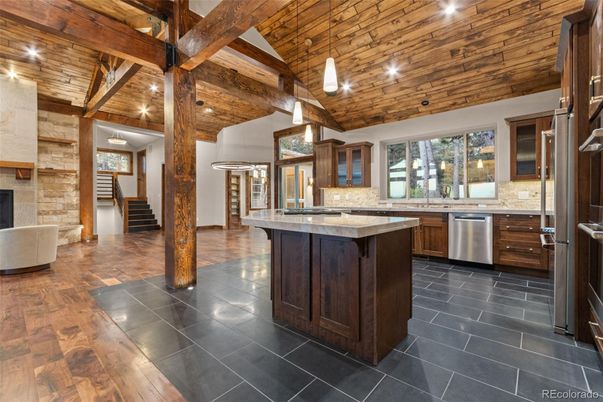 Fireplace, Interior, Kitchen, Pendant Lights, Recessed Lighting, Stainless Steel Appliances, Wooden Beams, Wooden Ceilings, Wood Texture Flooring
