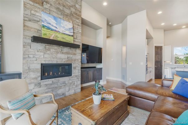 Fireplace, Interior, Living room, Recessed Lighting, Stone Walls, Wood Texture Flooring