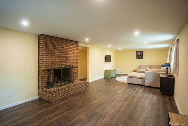 Fireplace, Interior, Living room, Recessed Lighting, Stone Walls, Wood Texture Flooring
