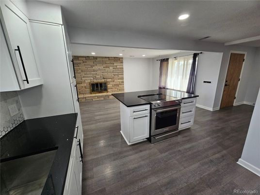 Fireplace, Interior, Kitchen, Recessed Lighting, Stone Walls, Wood Texture Flooring