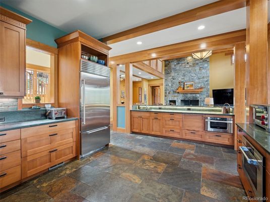 Fireplace, Interior, Kitchen, Recessed Lighting, Stainless Steel Appliances, Stone Walls