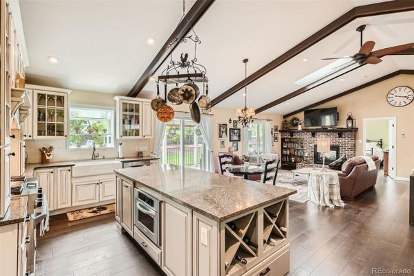 Chandelier, Dining room, Fireplace, Interior, Kitchen, Living room, Recessed Lighting, Stainless Steel Appliances, Stone Walls, Wooden Beams, Wood Texture Flooring
