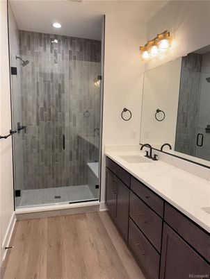 Bathroom, Dual Sink Vanities, Glass Shower, Interior, Recessed Lighting, Wood Texture Flooring